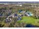Expansive aerial view of the community clubhouse, pool, tennis courts, and golf course at 8706 52Nd E Dr, Bradenton, FL 34211