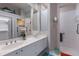 Bathroom featuring double sink vanity, walk in shower, and a clean design at 8706 52Nd E Dr, Bradenton, FL 34211