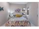 Comfortable bedroom with colorful bedding, white side tables, and natural light from the window at 8706 52Nd E Dr, Bradenton, FL 34211
