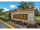 Stone Rosedale community sign with plants and wooden pergola accents sits under blue skies at 8706 52Nd E Dr, Bradenton, FL 34211