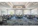 An elegant dining room with large windows and stylish decor is set for a delightful experience at 8706 52Nd E Dr, Bradenton, FL 34211