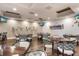 Modern dining room featuring hardwood floors, stylish wall decor, and multiple TVs for entertainment at 8706 52Nd E Dr, Bradenton, FL 34211
