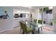 Bright dining area featuring a modern glass table, green chairs, and natural lighting at 8706 52Nd E Dr, Bradenton, FL 34211