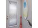 Hallway featuring a frosted glass door with beautiful artwork and beach-themed decor at 8706 52Nd E Dr, Bradenton, FL 34211