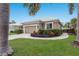 Charming home with a well-manicured lawn, lush landscaping, and an attached garage at 8706 52Nd E Dr, Bradenton, FL 34211