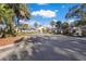 Charming exterior view of the clubhouse, with palm trees and well-kept landscaping at 8706 52Nd E Dr, Bradenton, FL 34211