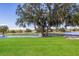 A view of a lush green golf course with a bridge going over a pond on a clear sunny day at 8706 52Nd E Dr, Bradenton, FL 34211