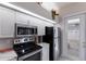 Efficient kitchen with stainless steel appliances, white cabinets, and a convenient layout at 8706 52Nd E Dr, Bradenton, FL 34211