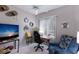 Home office with desk, ergonomic chair, TV, and unique wall decor at 8706 52Nd E Dr, Bradenton, FL 34211