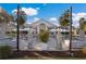 Outdoor patio with lounge and dining areas, framed by palm trees and string lights for a relaxing experience at 8706 52Nd E Dr, Bradenton, FL 34211