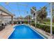 Enclosed pool with lush landscaping offering privacy and shade at 8706 52Nd E Dr, Bradenton, FL 34211