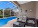 Screened-in pool area featuring a seating area and lush landscaping at 8706 52Nd E Dr, Bradenton, FL 34211