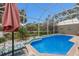 Screened in pool area with lush landscaping and outdoor seating offers the ideal relaxation space at 8706 52Nd E Dr, Bradenton, FL 34211