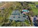 Overhead view of community tennis courts, surrounded by lush landscaping and golf course at 8706 52Nd E Dr, Bradenton, FL 34211