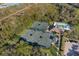 High angle view of a community tennis courts and pool, surrounded by lush landscaping and parking at 8706 52Nd E Dr, Bradenton, FL 34211