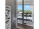 Balcony view overlooking lush greenery and scenic waterfront vistas from a distance at 8977 Midnight Pass Rd # 521, Sarasota, FL 34242
