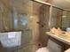 Bathroom with a glass enclosed shower and tiled walls and floor at 8977 Midnight Pass Rd # 521, Sarasota, FL 34242