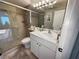 Clean bathroom featuring a glass shower door, large mirror, and ample counter space at 8977 Midnight Pass Rd # 521, Sarasota, FL 34242