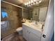 Bathroom featuring a glass shower door, white cabinets, and ample counter space at 8977 Midnight Pass Rd # 521, Sarasota, FL 34242
