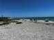 Wide sandy beach with gentle waves and people enjoying the sunny day at 8977 Midnight Pass Rd # 521, Sarasota, FL 34242