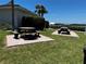 Exterior common area features brick picnic tables with benches, and lush lawns at 8977 Midnight Pass Rd # 521, Sarasota, FL 34242