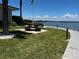 Picturesque common area with picnic tables overlooking the waterfront, perfect for outdoor relaxation at 8977 Midnight Pass Rd # 521, Sarasota, FL 34242