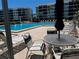 Community pool featuring outdoor seating, sunny lounge area, and pristine water for relaxation and enjoyment at 8977 Midnight Pass Rd # 521, Sarasota, FL 34242