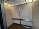 Interior view of an elevator with wood-paneled walls, a metal handrail and a ceiling light at 8977 Midnight Pass Rd # 521, Sarasota, FL 34242