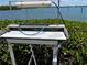 Fish cleaning station with running water and a light, set amidst natural vegetation near the water at 8977 Midnight Pass Rd # 521, Sarasota, FL 34242