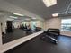 Community gym with mirrored wall, equipment and free weights at 8977 Midnight Pass Rd # 521, Sarasota, FL 34242