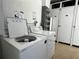 Community laundry room with a washing machine and dryer at 8977 Midnight Pass Rd # 521, Sarasota, FL 34242