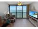 Inviting living room with views, comfortable chair, and updated media center at 8977 Midnight Pass Rd # 521, Sarasota, FL 34242