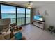 Bright living room featuring expansive water views, tile flooring, and comfortable seating at 8977 Midnight Pass Rd # 521, Sarasota, FL 34242