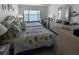 Cozy main bedroom featuring large window, decorative lamps, dresser, and waterfront view at 8977 Midnight Pass Rd # 521, Sarasota, FL 34242