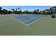 Outdoor tennis court, green surface and blue lines at 8977 Midnight Pass Rd # 521, Sarasota, FL 34242