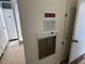 Community trash chute in a hallway with instructions and adjacent storage lockers at 8977 Midnight Pass Rd # 521, Sarasota, FL 34242