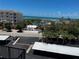 Balcony view of neighborhood, the beach, and the water under a blue sky at 8977 Midnight Pass Rd # 521, Sarasota, FL 34242