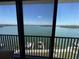 Stunning water views from the balcony showcase boats docked below on a sunny day at 8977 Midnight Pass Rd # 521, Sarasota, FL 34242