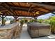 Outdoor patio features a hot tub, bar with seating and covered area perfect for entertaining in style at 9089 Berendo Ave, Englewood, FL 34224