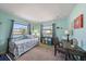 This light and airy bedroom offers 2 large windows for natural light and coastal decor at 9089 Berendo Ave, Englewood, FL 34224