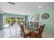 Dining room with table and chairs, and sliding glass doors to outdoor patio at 9089 Berendo Ave, Englewood, FL 34224