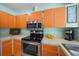 Well-lit kitchen featuring stainless steel appliances and ample counter space at 9089 Berendo Ave, Englewood, FL 34224