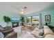 Inviting living room featuring tile floors, a large window, and comfortable seating at 9089 Berendo Ave, Englewood, FL 34224
