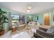 Bright living room with comfortable seating, neutral decor, and large window at 9089 Berendo Ave, Englewood, FL 34224