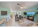Bright living room offers tile flooring, neutral paint and ample space for comfortable seating and entertaining at 9089 Berendo Ave, Englewood, FL 34224