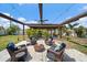 Inviting backyard patio space with comfortable seating, ambient lighting, and a cozy stone fire pit at 9089 Berendo Ave, Englewood, FL 34224
