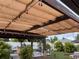 Inviting outdoor living space featuring a covered pergola with ambient lighting and a full outdoor kitchen at 9089 Berendo Ave, Englewood, FL 34224