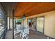 Covered patio featuring outdoor table with chairs, with access to multiple rooms at 9089 Berendo Ave, Englewood, FL 34224