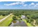 Sprawling property featuring a large pond with a fountain, lush greenery and lots of privacy at 919 Palm View Way, Sarasota, FL 34240