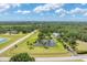 Expansive property featuring a serene pond with a fountain, lush greenery and privacy at 919 Palm View Way, Sarasota, FL 34240